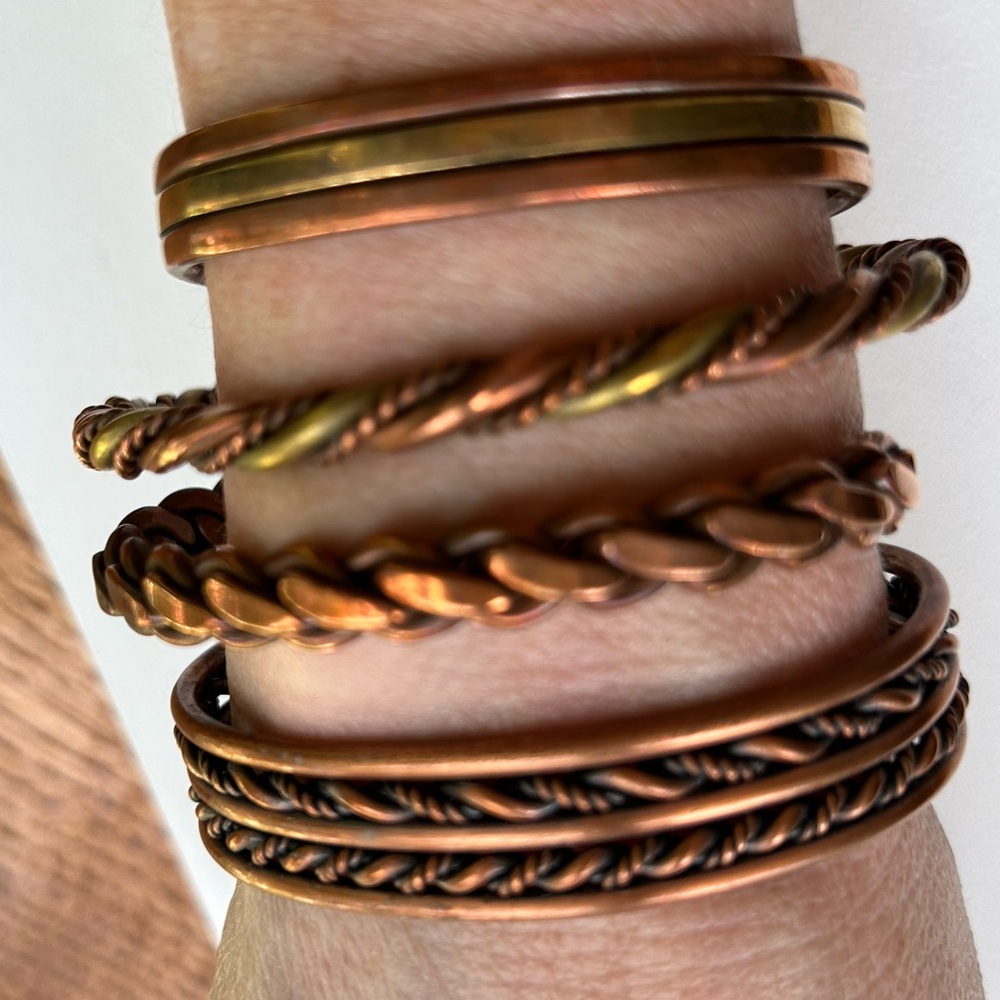 Four copper and brass bracelets.  They are all adjustable by bending or pinch